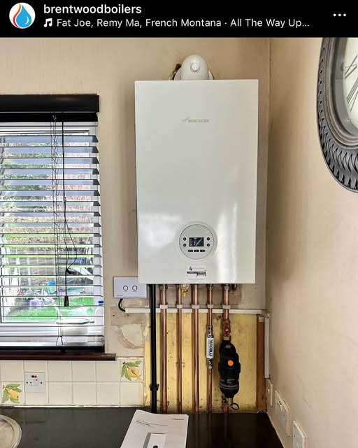 A boiler installed in a kitchen beside a window