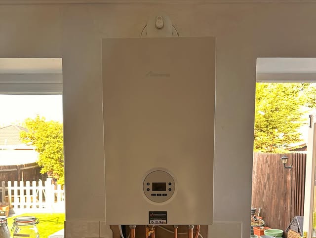 A finished boiler installation between two doorways in a Brentwood home, daylight from the garden on both sides